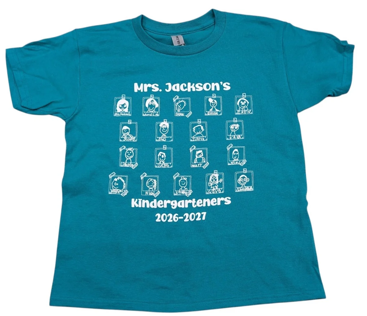 Teal kindergarten class shirt printed in white with students’ self-portrait drawings